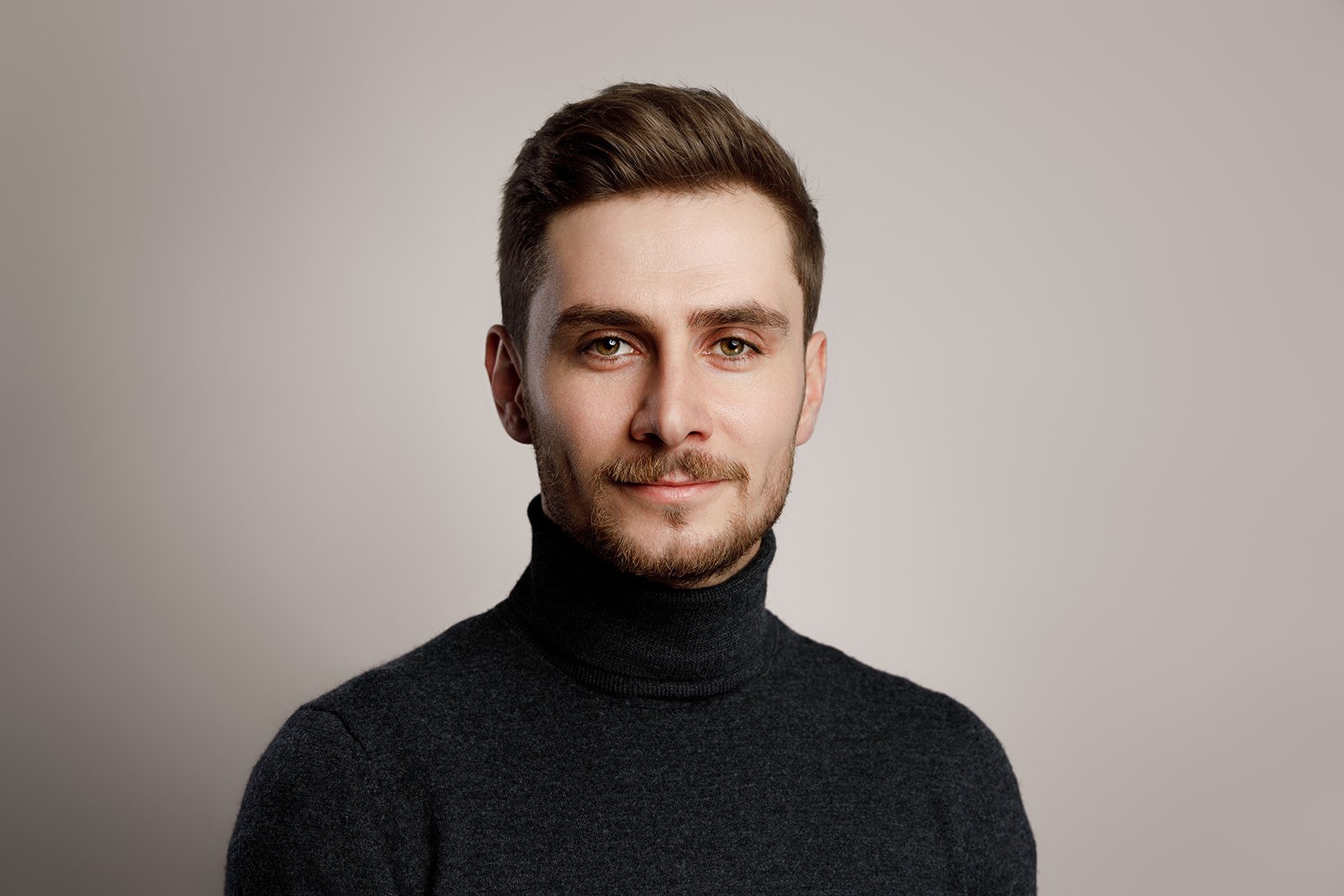 Minimalist Studio Portrait of a Man in Dark Clothes Elegant studio portrait of a man wearing dark clothing – focus on facial expression and personality